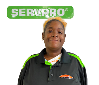 Kennisha Fleming, SERVPRO employee, green sign