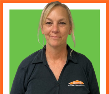 Cheryl, SERVPRO employee, cut out and set against a green backdrop