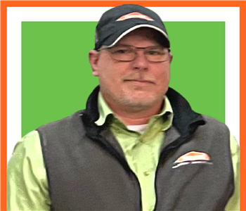 Chuck Tucker a SERVPRO employee, male, glasses and hat