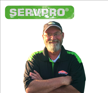 SERVPRO employee RJ Barnett, male with hat on and posing outside
