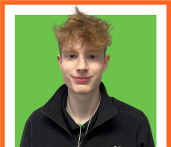 SERVPRO employee in front of green background