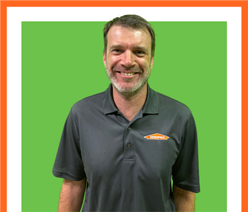 SERVPRO employee in front of green background