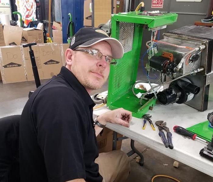 Male employee Chuck repairing equipment