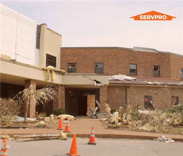 brown and orange brick commercial building large loss restoration, servpro orange house logo in top right