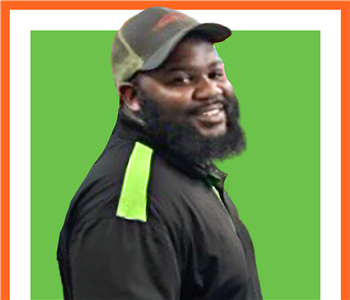 male, SERVPRO employee in front of green background